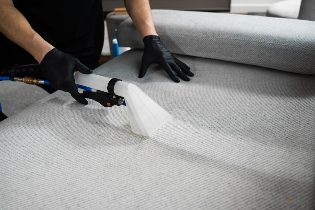 A sofa being cleaned